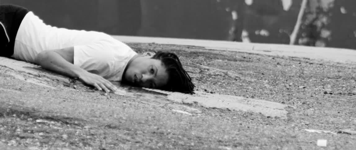 A young man lying in a pool of blood