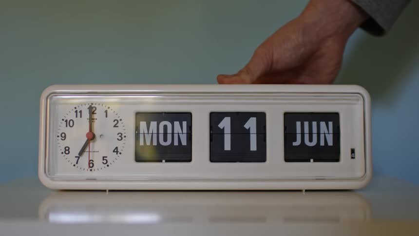 Someone changing the date on a clock radio