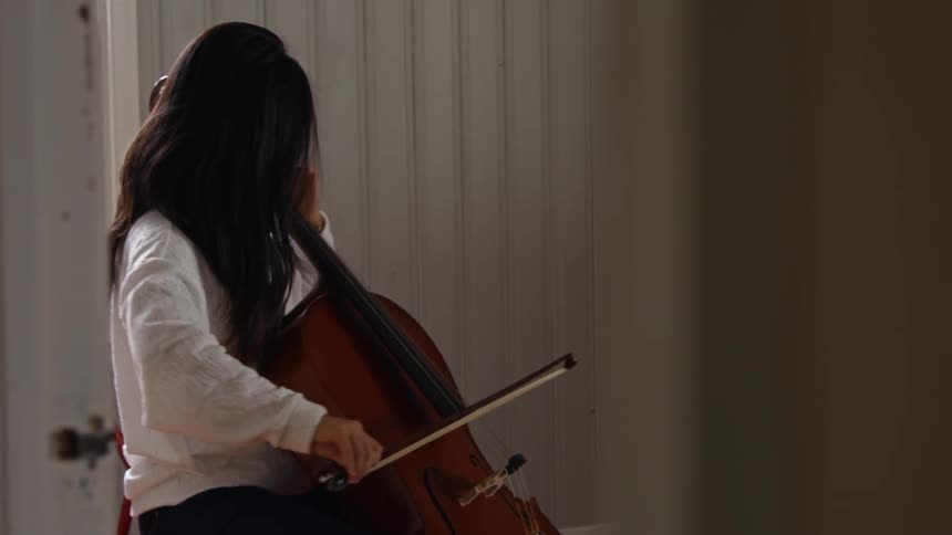 A woman practicing the cello
