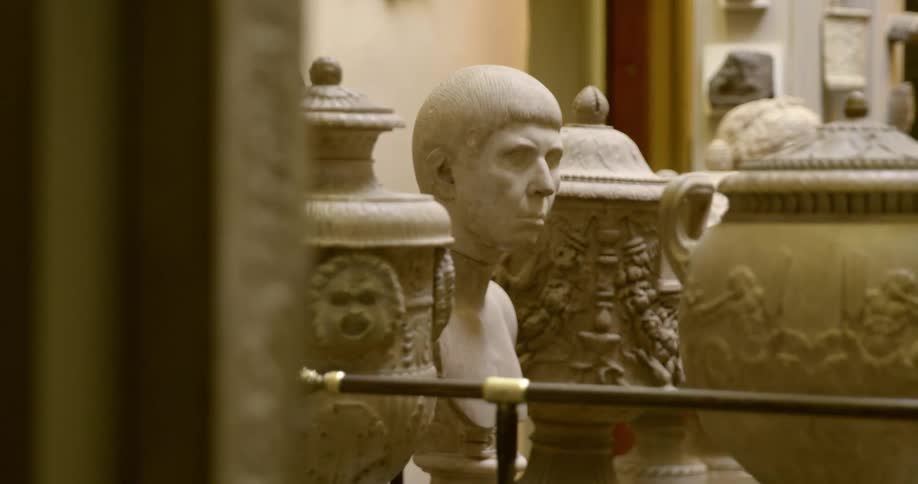 Statues and sculptures with a wall in the background