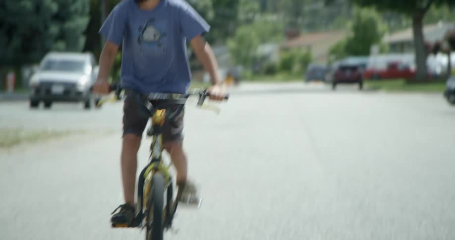 Two children riding bikes on a street