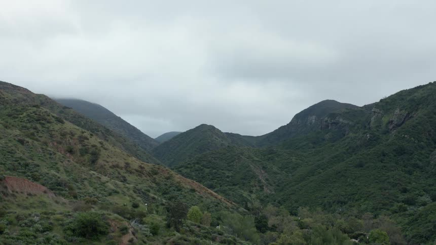 Aerial view of nature and hills is displayed during the day