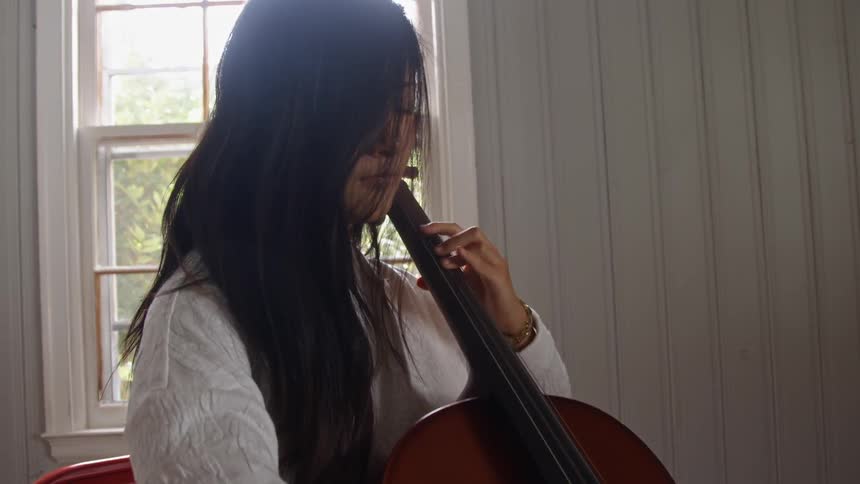 A woman playing a cello