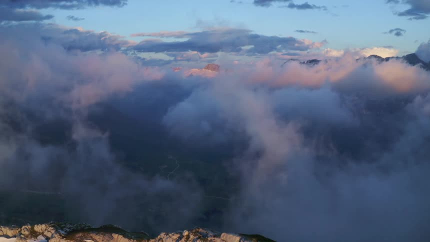 Dense clouds cover the tops of a mountain range