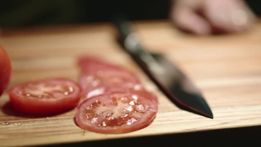 A tomato is cut into smaller pieces