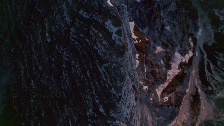 An aerial view of a snowy mountain range in winter