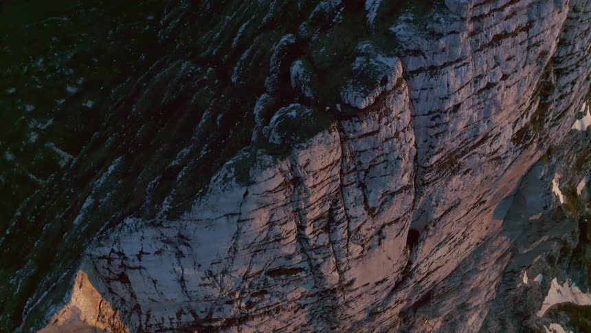 An aerial shot of a mountain cliff