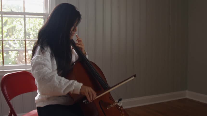 A woman playing cello