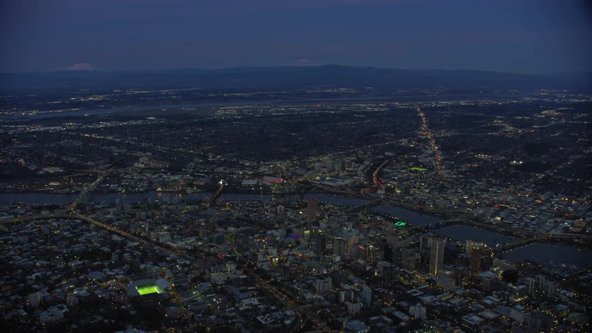 Super side aerial shot of downtown Portland Oregon in lovely blue hour post sunset light showing off the vast beauty of this charming city