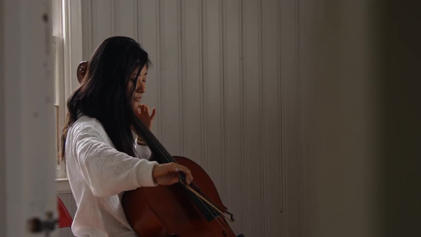 A woman is playing a large instrument