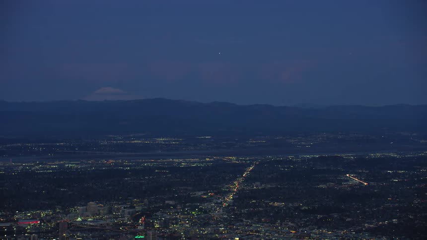 Aerial view of the Portland, Oregon city in the plains near the snow covered peak of the mountain Mount Hood at evening