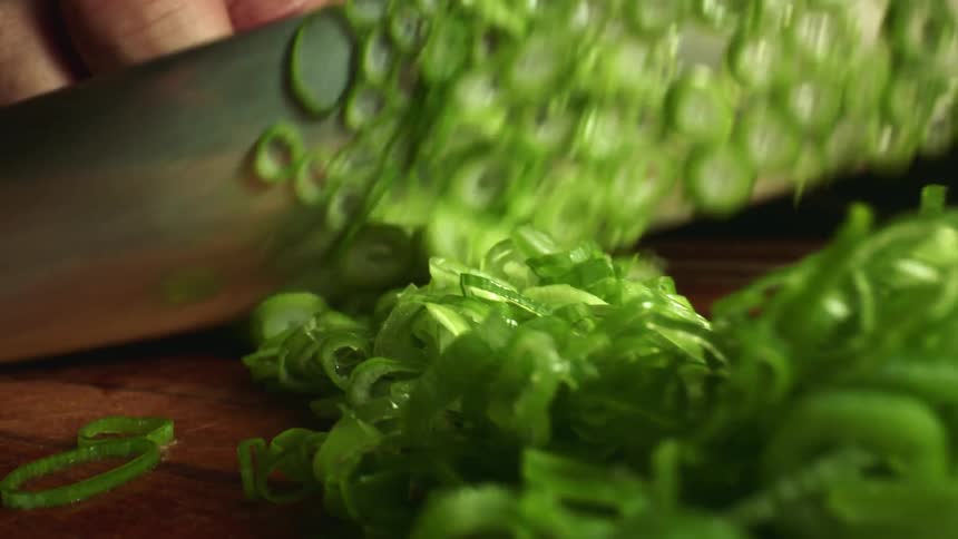 A man chopping onions at home