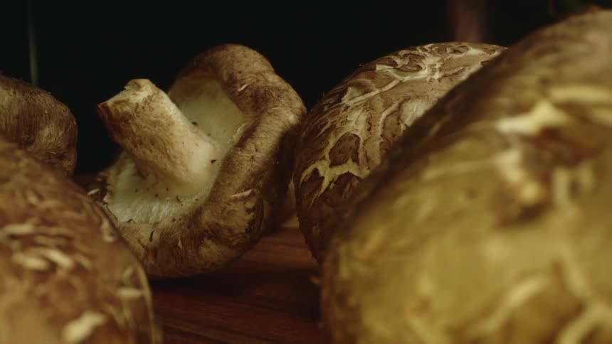 Mushrooms sitting on a wood cutting board