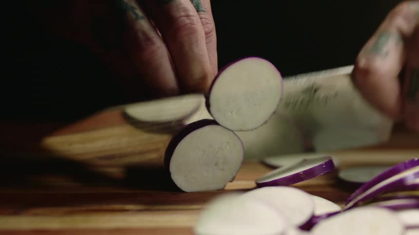 A person is slicing up a radish