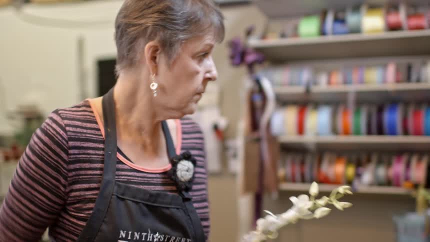 People are working in a flower shop arranging flowers
