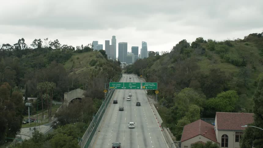 Vehicles driving over a highway heading for the citys downtown at daytime