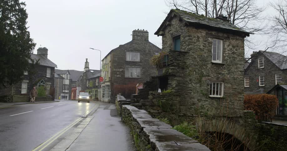 A car driving down a road in front of houses