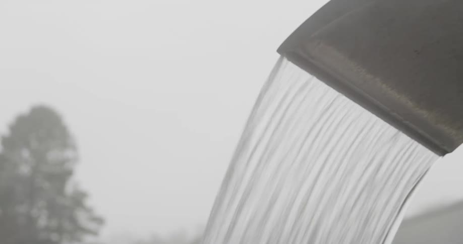Steam rising around water flowing from an outdoor faucet