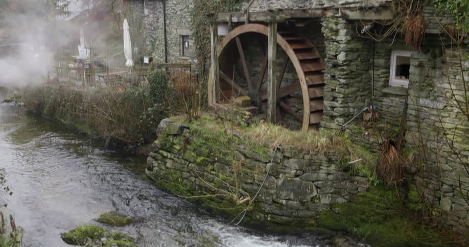 A shot of a water wheel on a river