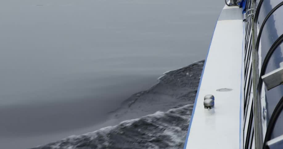 A boat gliding through water on a lake