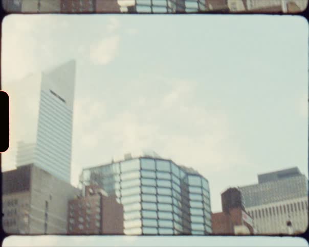 Vintage film footage of a teenage girl playing a guitar in a city