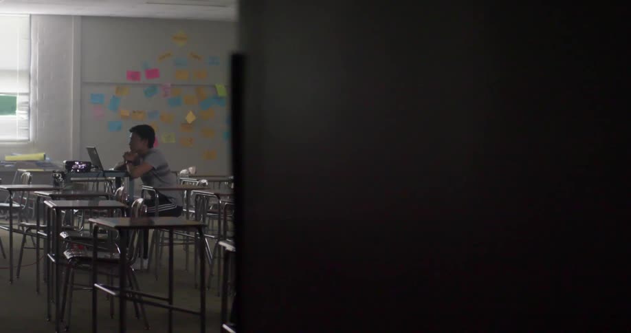 A student sitting at a desk in a classroom
