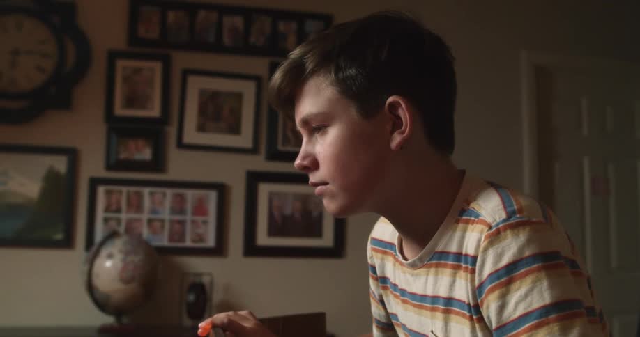 A teenager sitting at a table