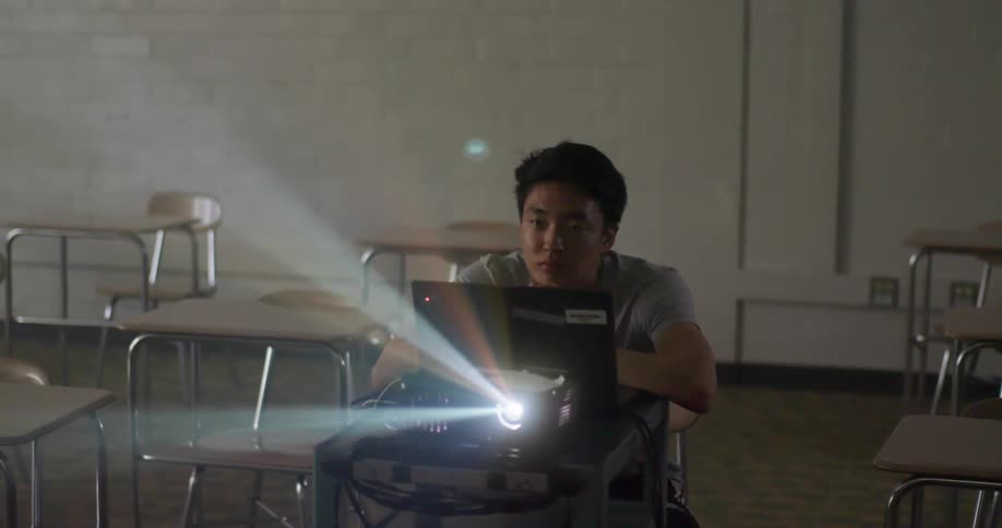 A man working on a laptop and projector