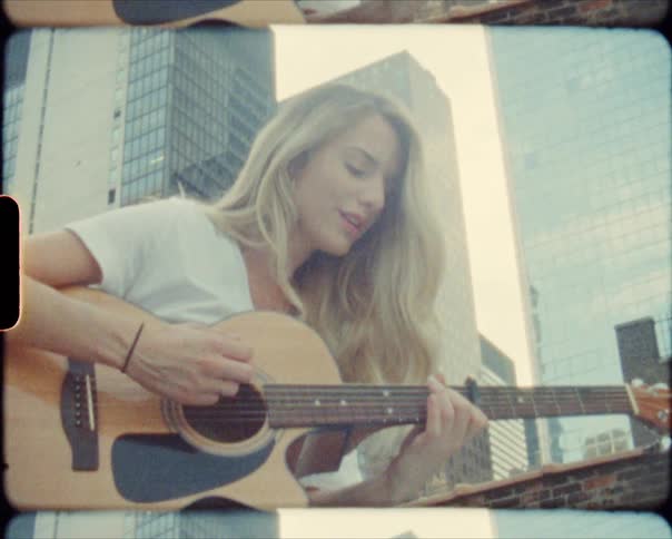 A woman playing the guitar