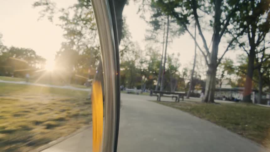 A person is riding a bike through a park in spring