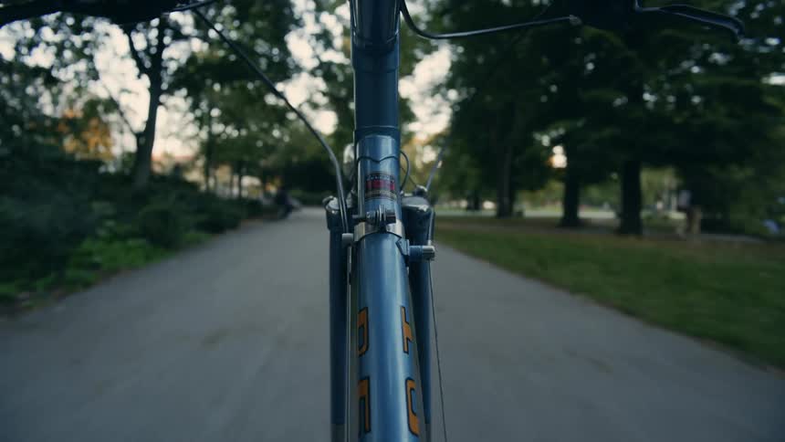 Aperson is riding a bike in spring during the day