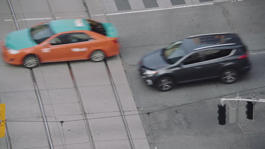 Traffic travels across a large intersection in a city during the day