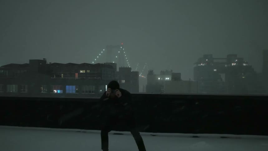 A man standing on a roof taking photos