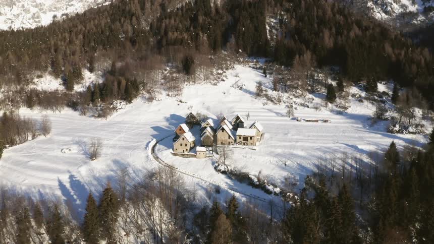 An aerial view of a small village in a snowy forest