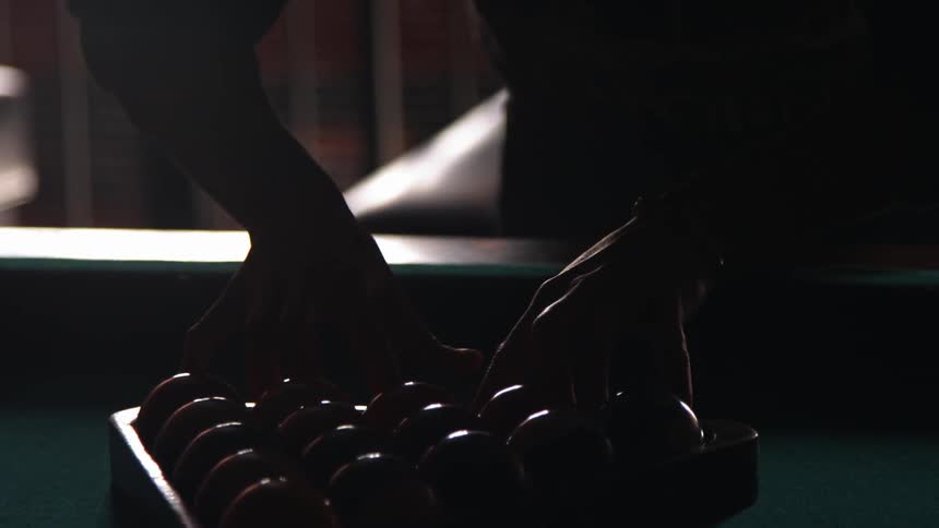 Pool balls are setup on a pool table
