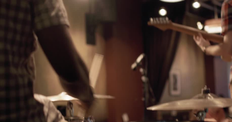 A drummer plays the drums on a stage