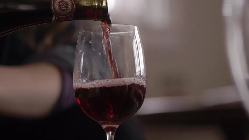 Wine being poured from a bottle into a glass