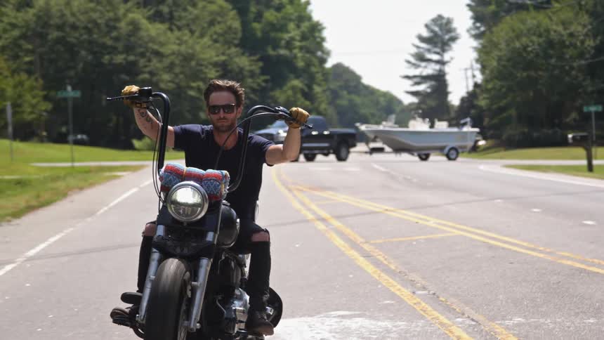 Men riding motorcycles along a road