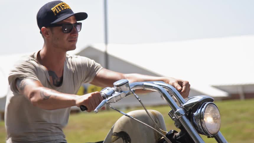 A man is riding a motorcycle in town