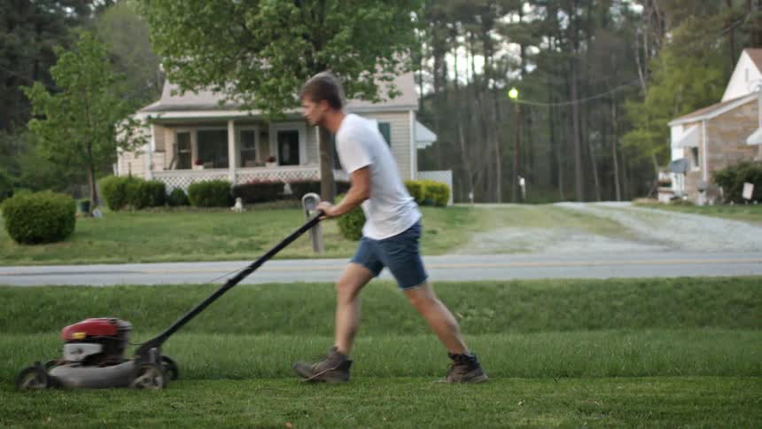 A man mowing grass