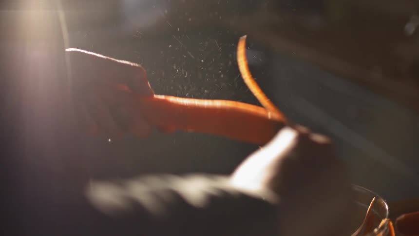 Close up of a person peeling carrots