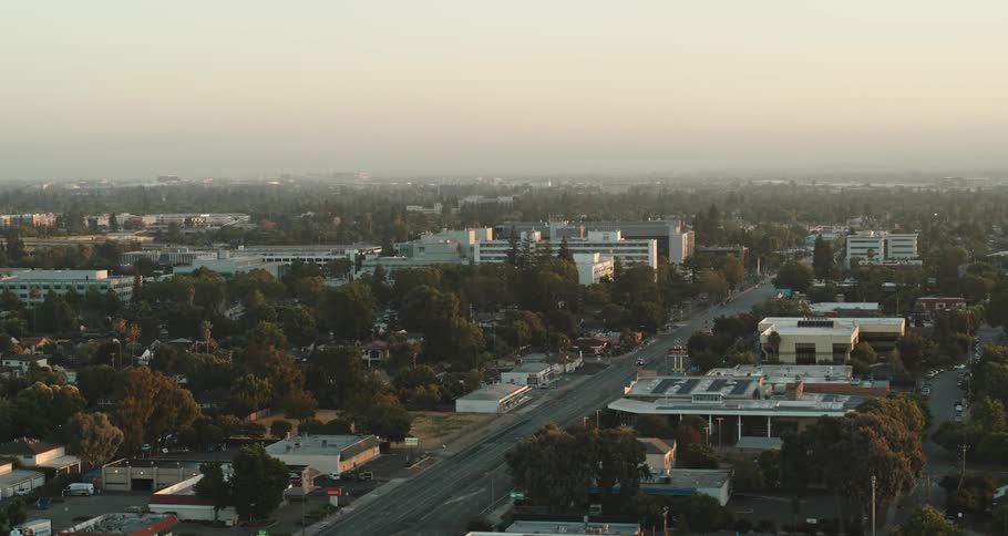A large road leading through a city on a cloudy day