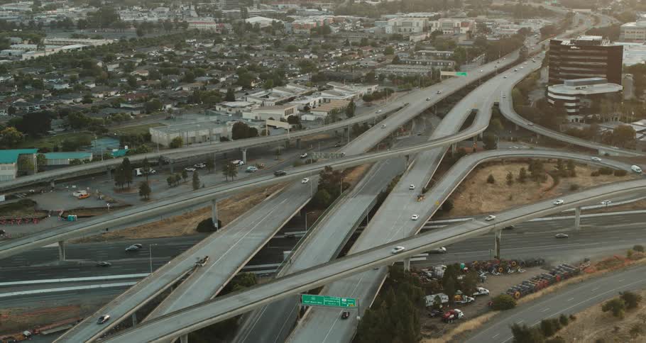 Traffic passes through a busy freeway interchange in a city