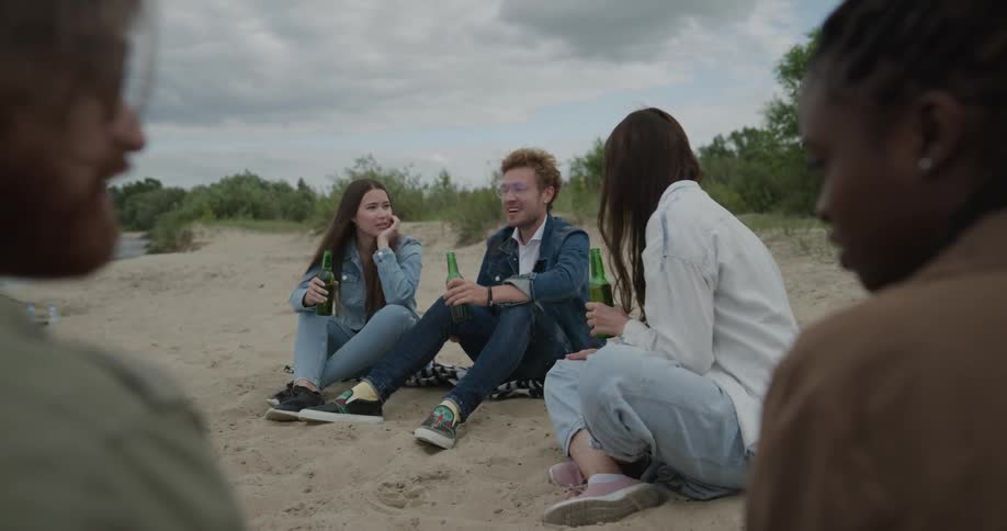 A group of people sitting at a beach