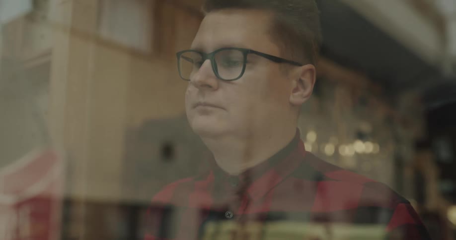 A man is in a store and moving an open sign