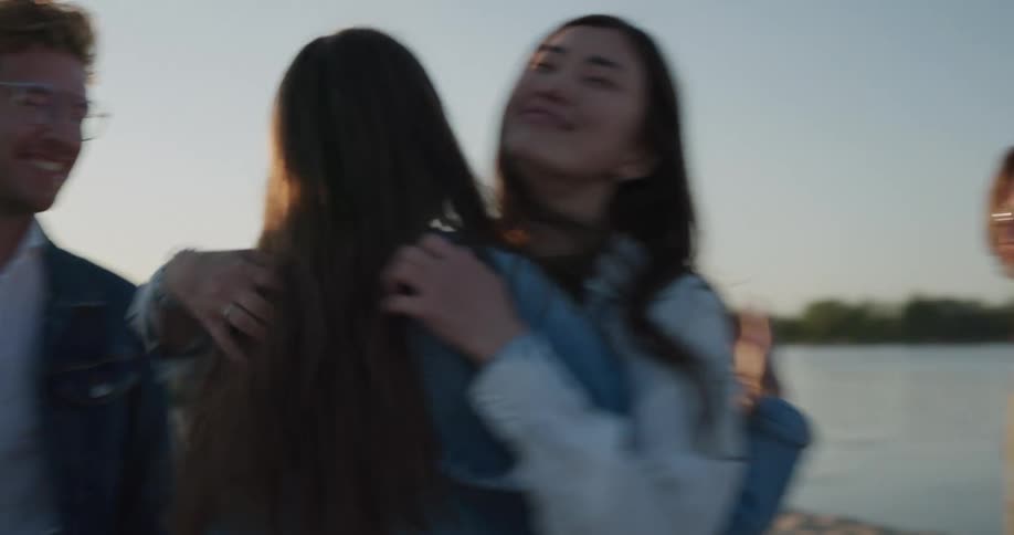 Friends are hanging out at the beach at dusk