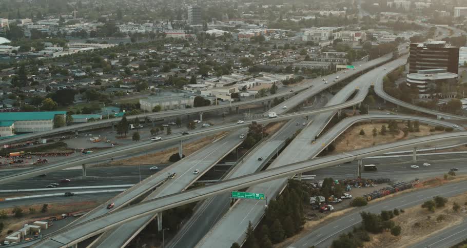 Busy city highways with many cars and buildings all around