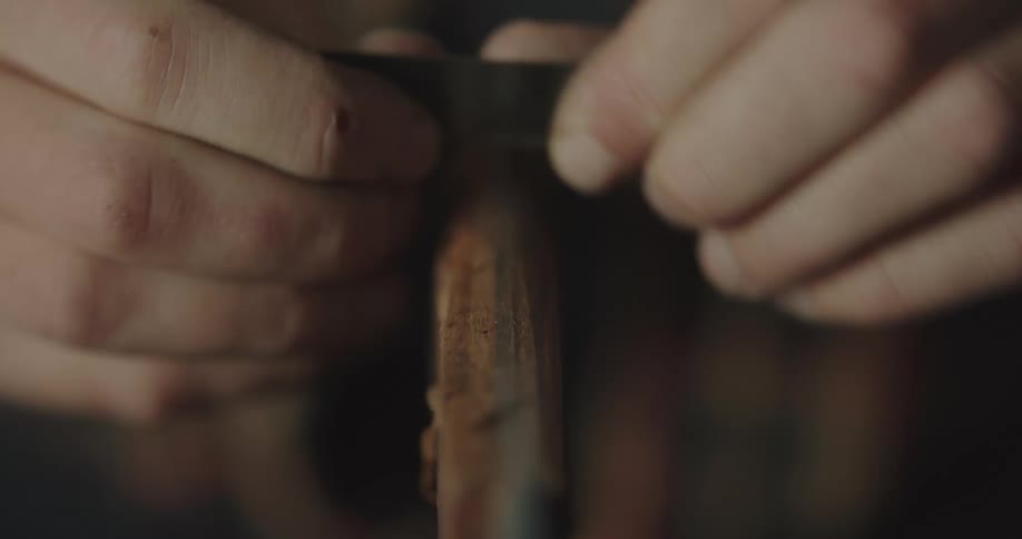 A close up of a person cutting wood