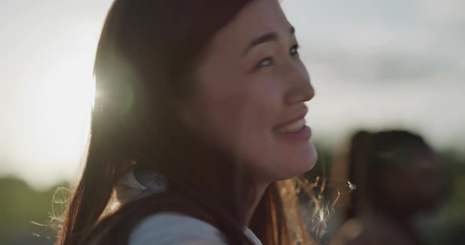 A woman laughs as she talks with someone outside