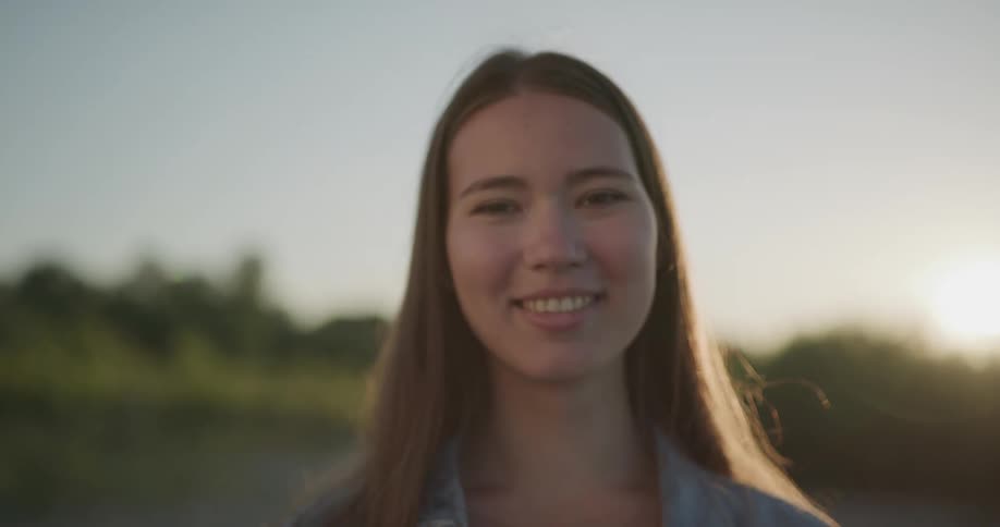 A woman standing in a field to get a portrait taken